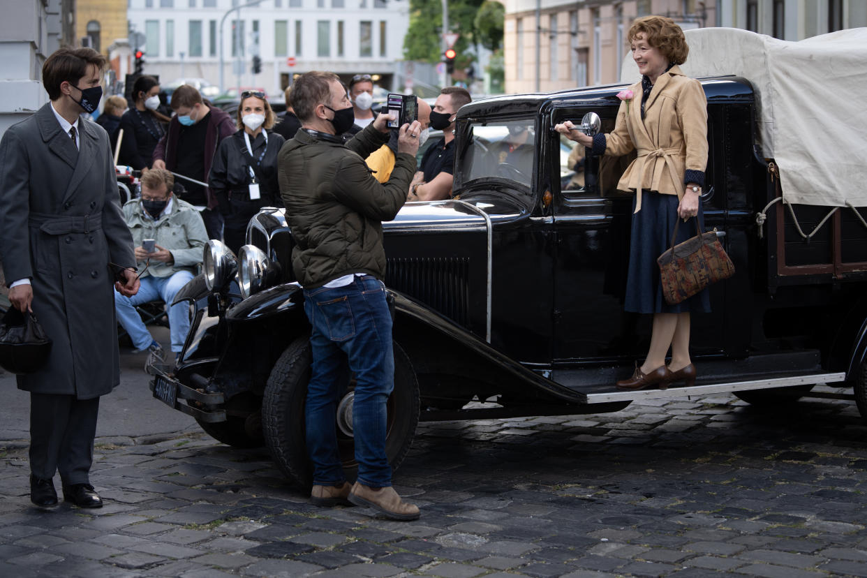 Lucas Bravo, Tony Fabian, and Lesley Manville on the set of “Mrs. Harris Goes to Paris” - Credit: Dávid Lukács