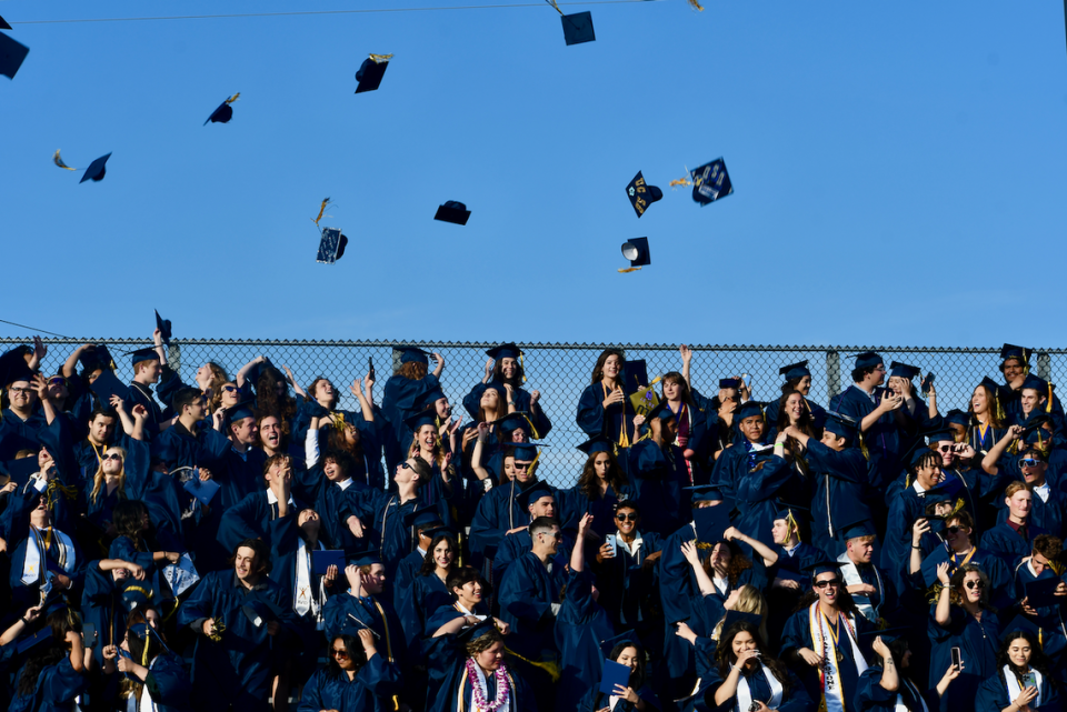 Arroyo Grande High School grads throw their caps in the air to celebrate their graduation during the commencement ceremony on June 8.