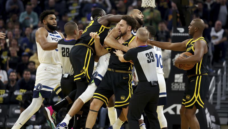 Golden State Warriors guard Klay Thompson, front, and Draymond Green, left, get into an altercation with Minnesota Timberwolves center Rudy Gobert, back, during the first half of an in-season NBA tournament basketball game in San Francisco, Tuesday, Nov. 14, 2023.