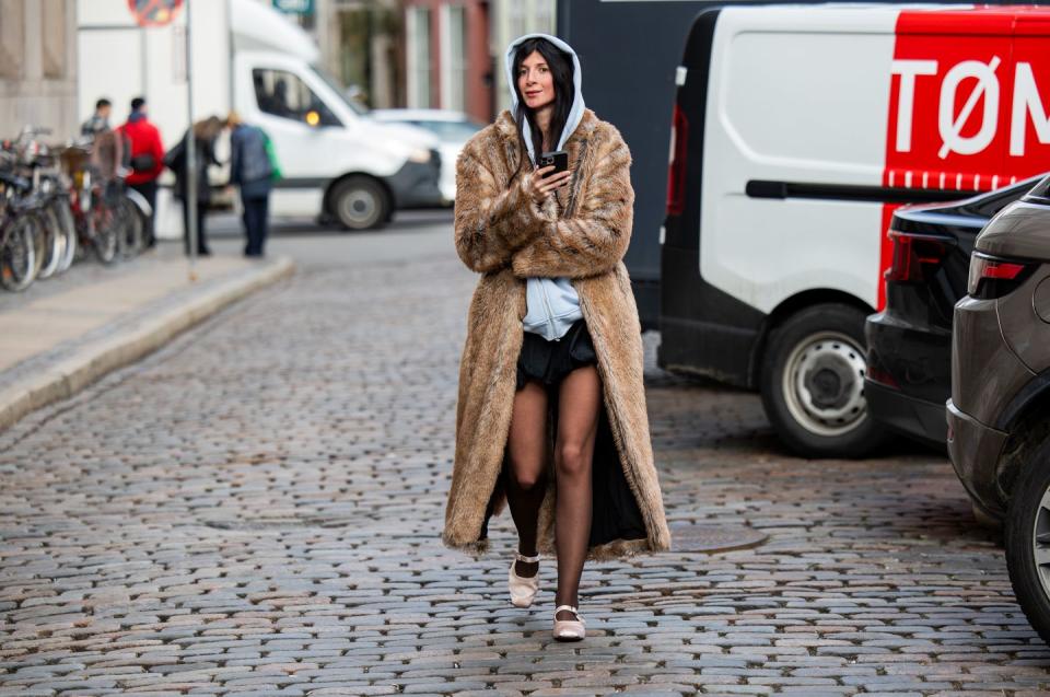 copenhagen, denmark january 29 a guest wears fur coat, grey hoody, tights outside nicklas skovgaard during the copenhagen fashion week aw24 on january 29, 2024 in copenhagen, denmark photo by christian vieriggetty images