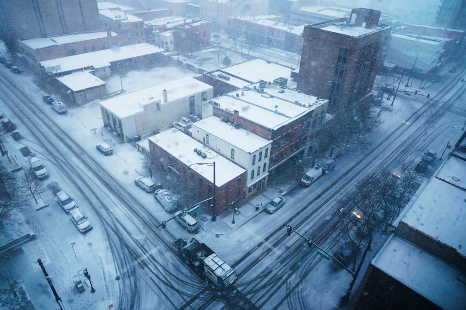 View of snow covered in downtown Waukegan, Ill., as a winter storm arrives Thursday, Feb. 16, 2023. (AP Photo/Nam Y. Huh)