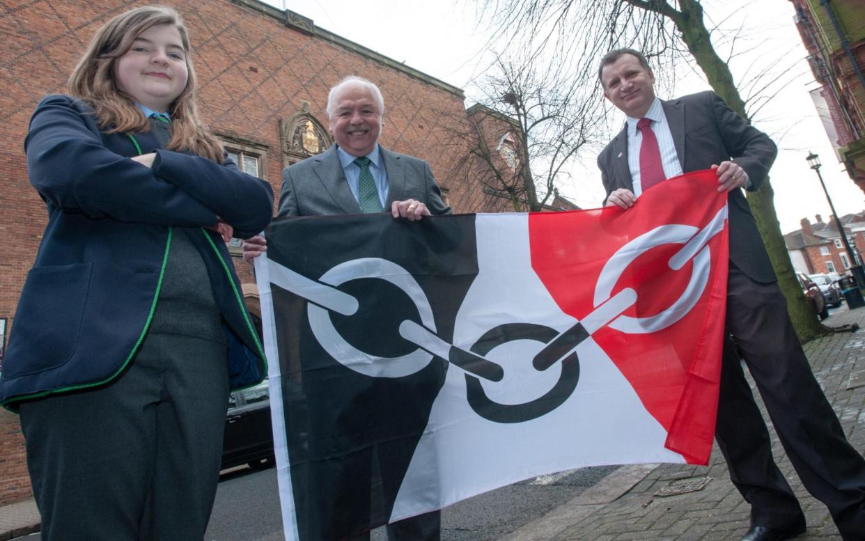 Gracie Sheppard with her flag design alongside council leaders in Dudley - Jane Williams /Alamy Stock Photo 