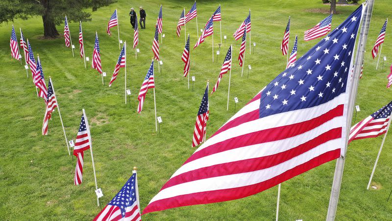 A couple walks through the Flags of Honor at Memorial Mountain View Cemetery in Cottonwood Heights on May 24, 2020. The flags honor soldiers who have died since 9-11.