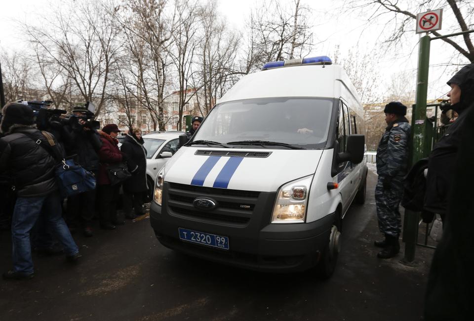 A police mini bus, which witnesses and journalists on site claim to be transporting the student involved in a shooting incident, drives out of a high school on the outskirts of Moscow