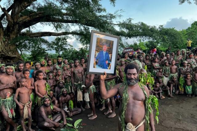 Villagers from Yaohnanen and Yakel on Vanuatu's Tanna island pose with a portrait of Britain's King Charles III on May 6, 2023, ahead of his coronation in London