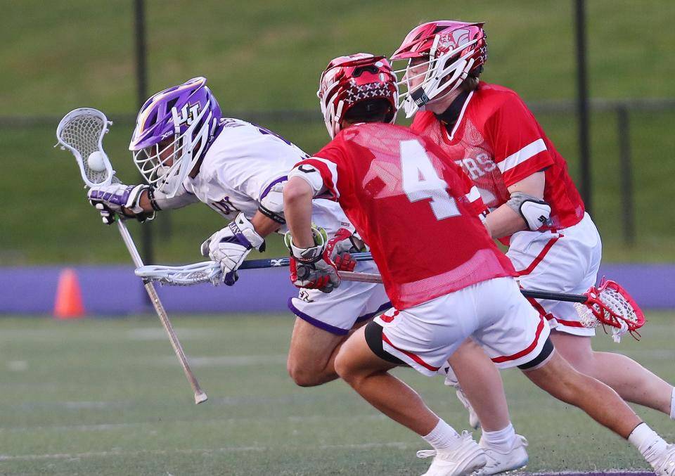 John Jay's Dom Savastano (15) gets chased by Somers Luca Ploger (4) and Luke Duffy (33) during lacrosse action at John Jay High School in Cross River May 7, 2024. John Jay won the game 11-10.