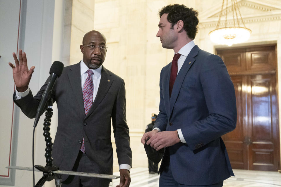 Sen. Raphael Warnock, D-Ga. left, accompanied by Sen. Jon Ossoff, D-Ga., speak to the media after Senate Democrats met privately with President Joe Biden, Thursday, Jan. 13, 2022 on Capitol Hill in Washington. ( AP Photo/Jose Luis Magana)