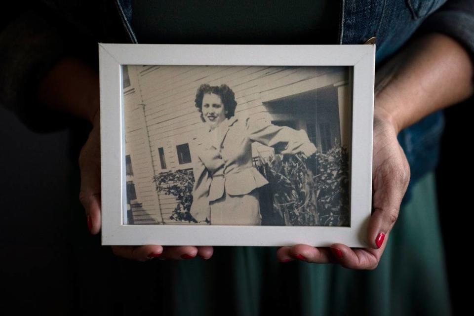 Stacy Cordova, whose aunt was a victim of California’s forced sterilization program that began in 1909, holds a framed photo of her aunt Mary Franco. Franco was sterilized when she was 13 in 1934.