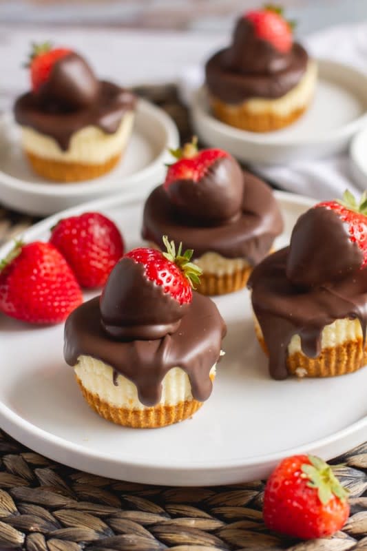 <p>Away From the Box</p><p>Light and airy mini cheesecakes with a graham cracker crust – they’re a delightful twist on the typical dense and creamy cheesecake!</p><p><strong>Get the recipe: <a href="https://www.awayfromthebox.com/chocolate-covered-strawberry-cheesecakes/" rel="nofollow noopener" target="_blank" data-ylk="slk:Chocolate-Covered Strawberry Mini Cheesecakes;elm:context_link;itc:0;sec:content-canvas" class="link rapid-noclick-resp">Chocolate-Covered Strawberry Mini Cheesecakes</a></strong></p>
