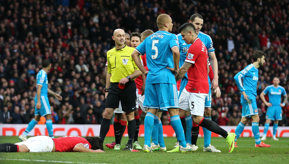 Football: Referee Roger East shows a red card to Sunderland's Wes Brown as John O'Shea looks on