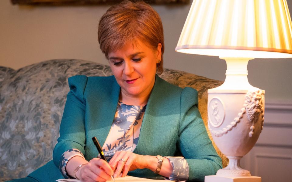 First Minister Nicola Sturgeon in the Drawing Room in Bute House, Edinburgh, working on the final draft of her Section 30 letter to the Prime Minister Theresa May formally requesting a second Scottish independence referendum - Credit: PA