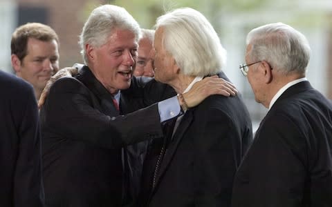 Graham is greeted by former US President Bill Clinton in 2007  - Credit: Davis Turner /Getty