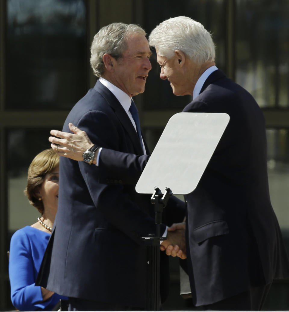 Former president George W. Bush, left, shakes hands with former president William J. Clinton during the dedication of the George W. Bush presidential library on Thursday, April 25, 2013, in Dallas. (AP Photo/David J. Phillip)