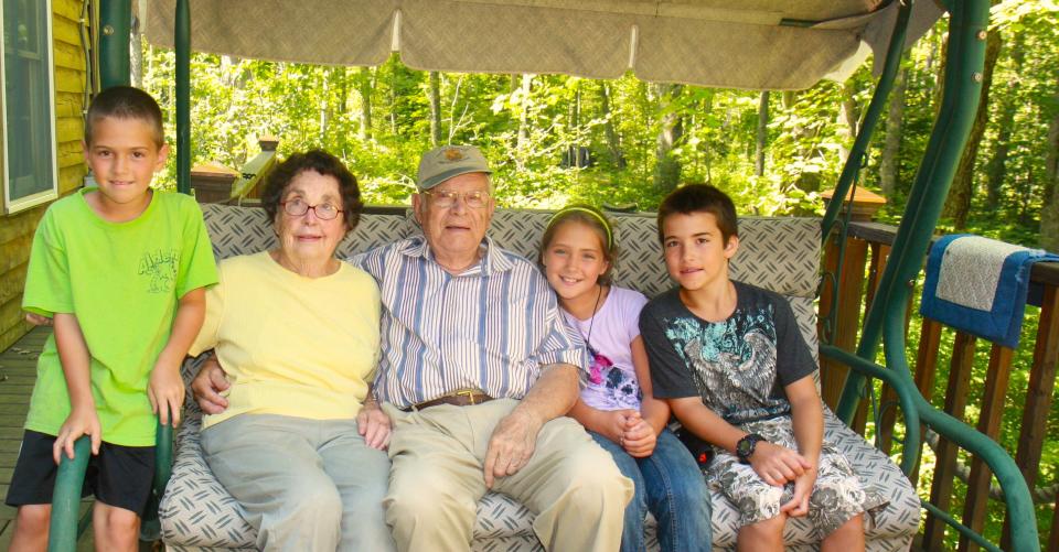 Merrill and Polly Leavens at their summer cabin in Maine with great-grandchildren. L to R: Noah Campbell, Polly, Merrill, Grace Campbell and Nathan Campbell.