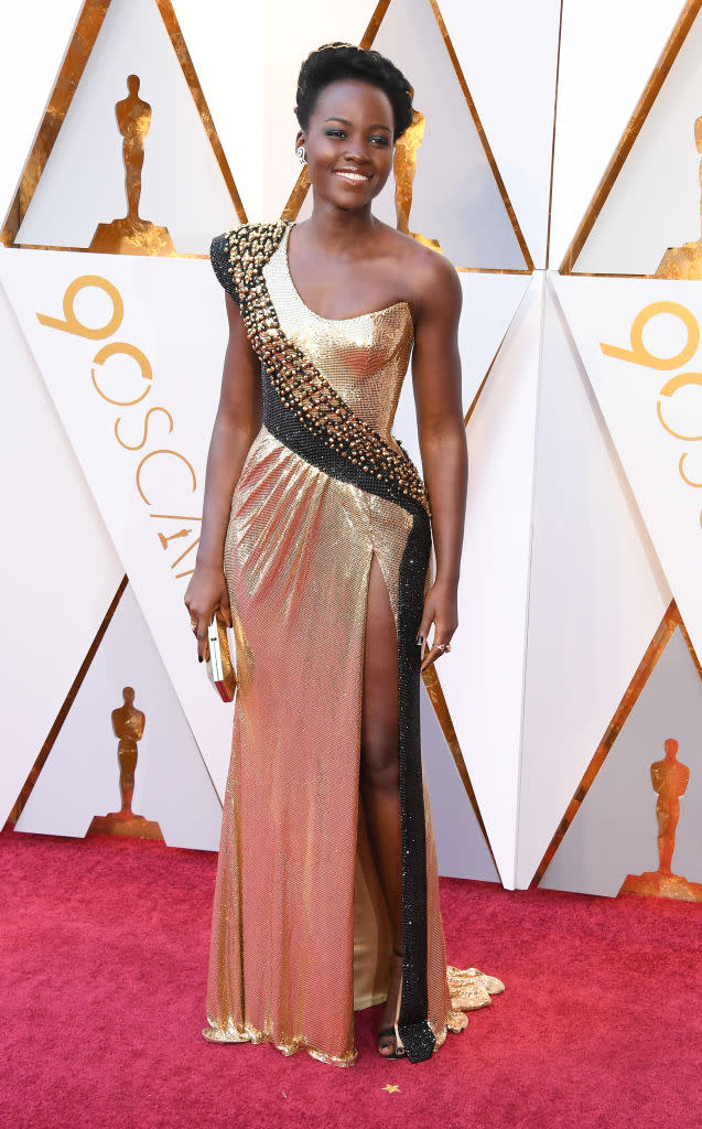 <p><em>Black Panther</em> star Lupita Nyong’o commanded attention in a custom gold dress from Atelier Versace. (Photo: Getty Images) </p>