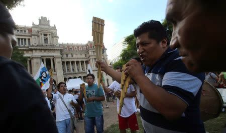 Supporters of Milagro Sala, the leader of the Tupac Amaru social welfare group, play instruments in front of a sign that reads "Free Milagro" as they gather to hear Sala's trial in San Salvador de Jujuy, with charges ranging from intimidation to corruption, on a radio outside a Justice building in Buenos Aires, Argentina, December 28, 2016. REUTERS/Marcos Brindicci