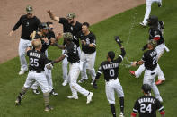 Chicago White Sox's Jose Abreu (79) celebrates with teammates after scoring on a wild pitch to defeat the Kansas City Royals during the ninth inning of a baseball game Sunday, May 16, 2021, in Chicago. (AP Photo/Paul Beaty)