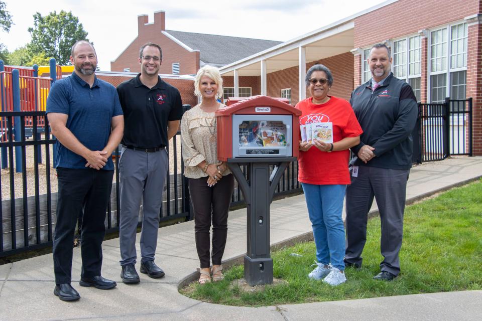 Alliance City Schools installed a new Little Free Library at Alliance Preschool in honor of retired educator and current ACS Board of Education member Elayne Dunlap. Showing off the library are, from Left: Kirk Heath, ACS treasurer; Adam De Monte, principal of Alliance Preschool; Michelle Balderson, director of elementary education; Dunlap; and Rob Gress, ACS superintendent.