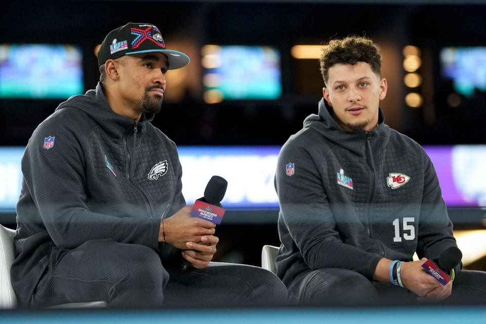 Kansas City Chiefs quarterback Patrick Mahomes, right, and Philadelphia Eagles quarterback Jalen Hurts speak to the media during the NFL football Super Bowl 57 opening night, Monday, Feb. 6, 2023, in Phoenix. The Kansas City Chiefs will play the Philadelphia Eagles on Sunday. (AP Photo/Matt York)