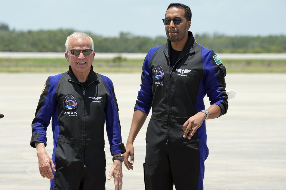 Members of the crew of the SpaceX Falcon 9 rocket, with the Crew Dragon spacecraft, pilot John Shoffner, left, and Saudi Arabian astronaut Ali al-Qarni arrive at the Kennedy Space Center in Cape Canaveral, Fla., before their launch to the International Space Station, Sunday, May 21, 2023. (AP Photo/John Raoux)