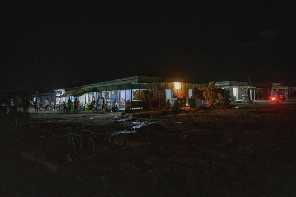 The main market in front of the clinic run by MSF (Doctors Without Borders), where surgeon and doctor-turned-refugee, Dr. Tewodros Tefera, goes to help staff, in Hamdayet, eastern Sudan, near the border with Ethiopia, on March 22, 2021. (AP Photo/Nariman El-Mofty)