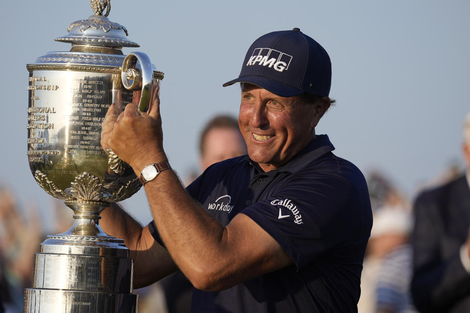 Phil Mickelson holds the Wanamaker Trophy after winning the PGA Championship golf tournament on the Ocean Course, Sunday, May 23, 2021, in Kiawah Island, S.C. (AP Photo/David J. Phillip)