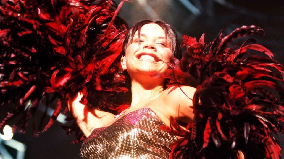 On stage, the memo was sequins, glitter and lamé. While performing at the Wembley Arena Victoria completed her high-shine look with a feather boa. - Mick Hutson/Redferns/Getty Images