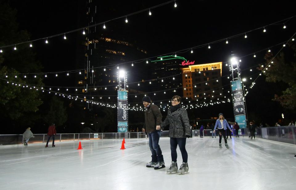 Peggy and Terry Hood skate together on the opening day of the Devon Ice Rink on the seasonal plaza of the Myriad Botanical Gardens Friday, November 8, 2019.