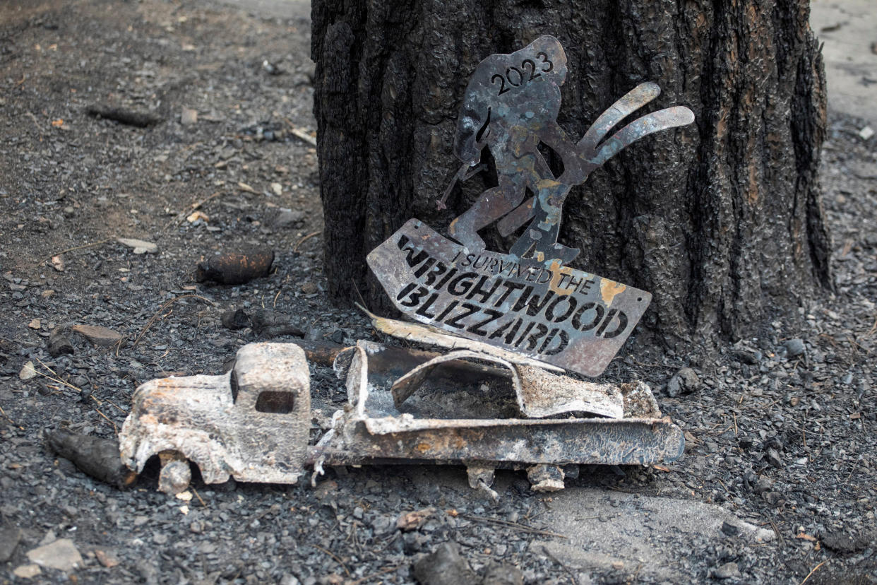 A charred sign lies on the ground after the Bridge Fire burned mountain communities to the northeast of Los Angeles, in Wrightwood, Calif., on Wednesday.