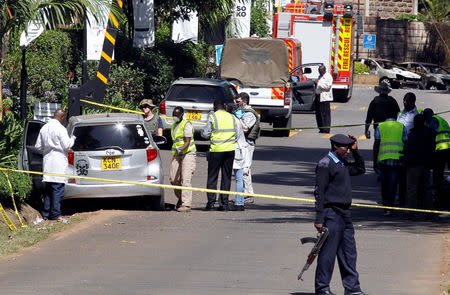 Kenyan policemen and explosives experts gather evidence from the car suspected to have been used by the attackers outside the scene where explosions and gunshots were heard at The DusitD2 complex, in Nairobi, Kenya January 17, 2019. REUTERS/Njeri Mwangi