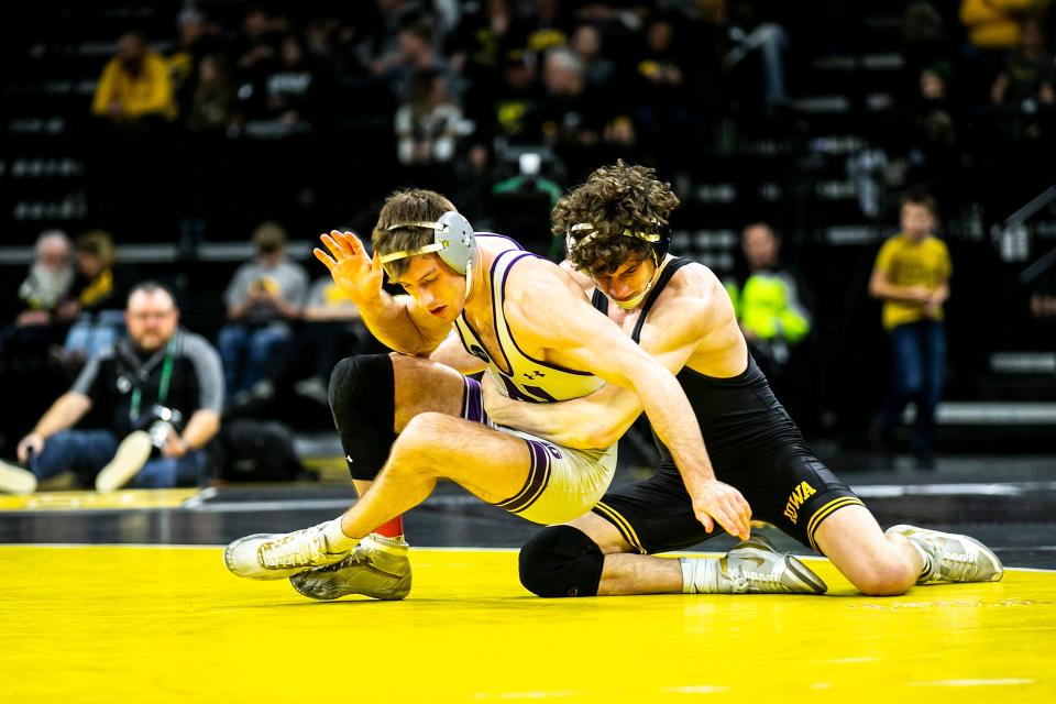 Iowa's Cobe Siebrecht, right, wrestles Northwestern's Trevor Chumbley at 157 pounds during a NCAA Big Ten Conference men's wrestling dual, Friday, Jan. 13, 2023, at Carver-Hawkeye Arena in Iowa City, Iowa.