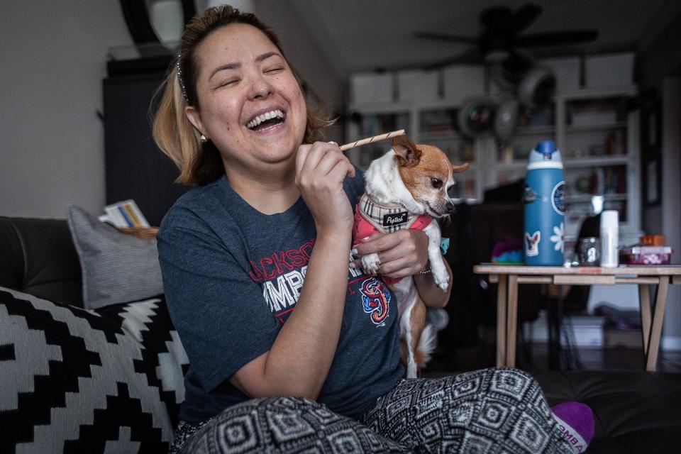 Maria Sanchez at her home with her dog Daisy Dukes in West Palm Beach. Sanchez was born with cystic fibrosis and underwent a double lung transplant in 2019. Medications keep her alive, she said. Her daily anti-rejection drugs will be routine for the rest of her life while other drug treatments treat her diabetes and keep her from getting infections that would likely kill her, she said.