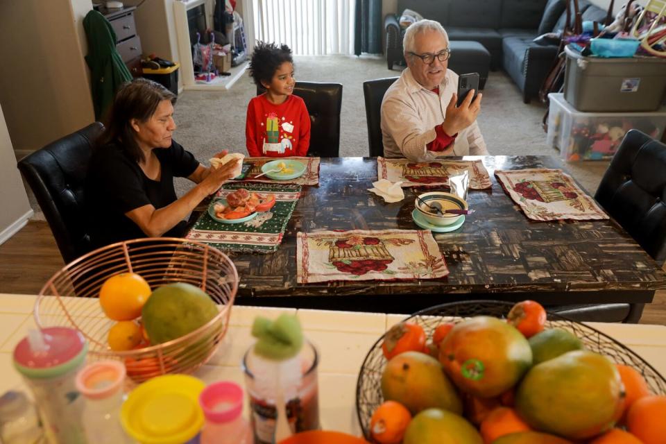 A man, woman and child at a breakfast table