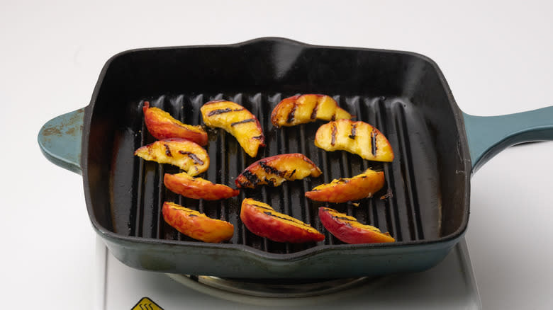 peach slices on griddle pan