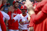 St. Louis Cardinals' Masyn Winn is congratulated by teammates after scoring a run during the seventh inning of a baseball game against the Arizona Diamondbacks, Wednesday, April 24, 2024, in St. Louis. (AP Photo/Scott Kane)