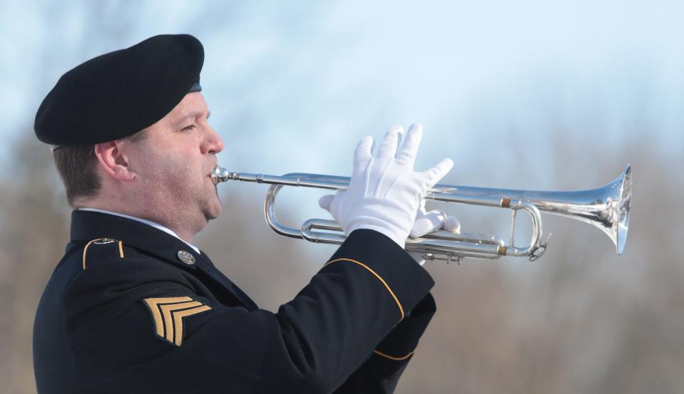 Maj. Marty Maggart with the 338th U.S. Army Reserve Command Band, plays "Taps" on Saturday at the annual wreath-laying ceremony honoring the birthday of President William McKinley.