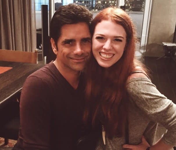 A fan posing with John Stamos on the set of "Grandfathered"