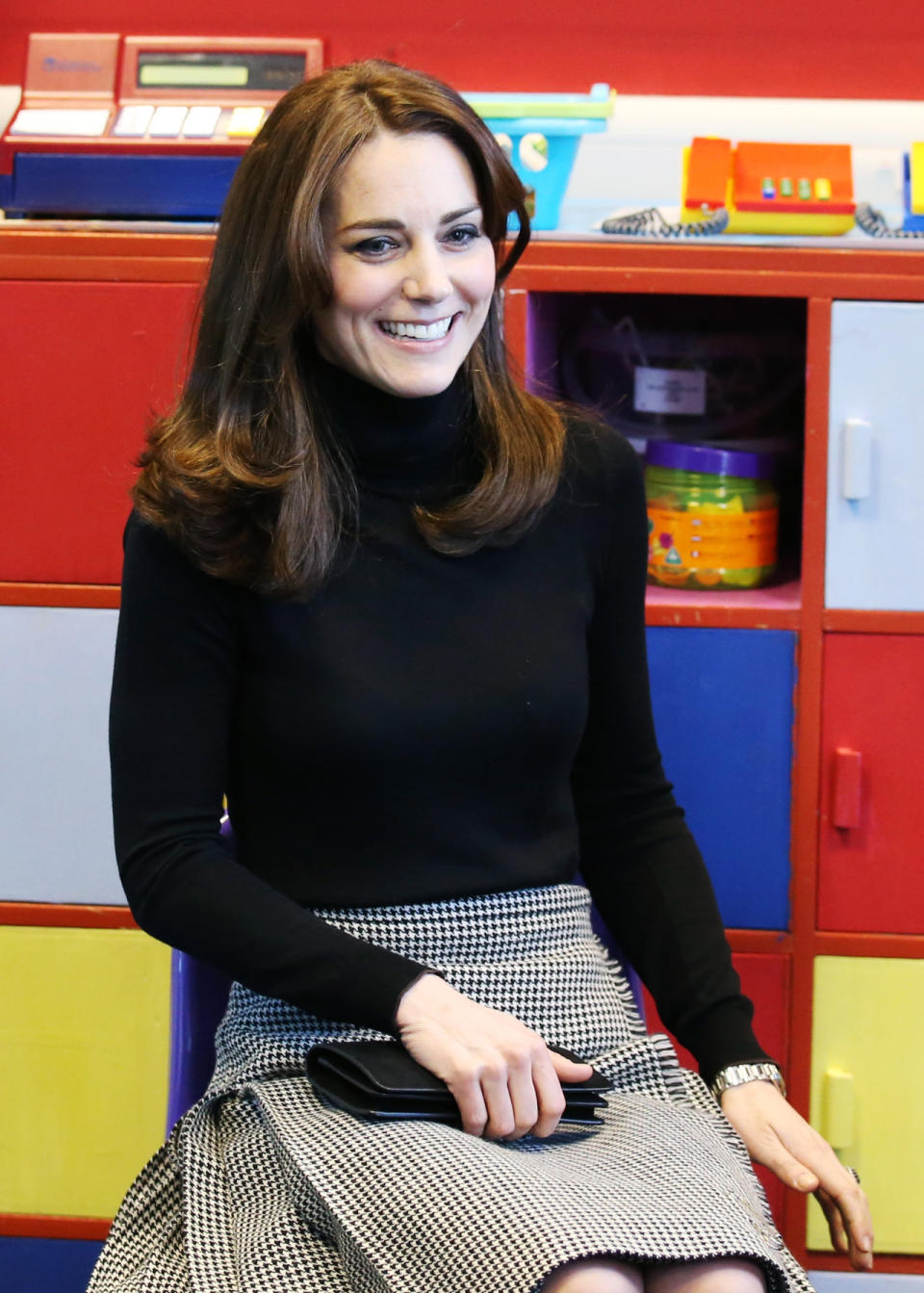 The Duchess of Cambridge in a houndstooth skirt from Le Kilt and a black turtleneck during her visit to a school on her trip to Scotland. 