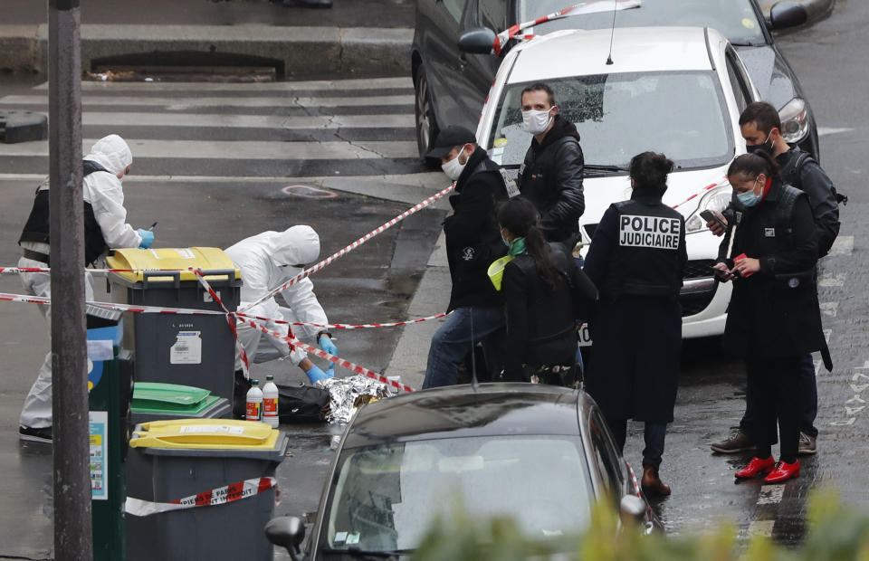 Police officers gather in the area of a knife attack near the former offices of satirical newspaper Charlie Hebdo, Friday Sept. 25, 2020 in Paris. Paris police say they have arrested a man suspected of a knife attack that wounded at least two people near the former offices of satirical newspaper Charlie Hebdo. Police initially thought there were two attackers but now say there was only one. (AP Photo/Thibault Camus)