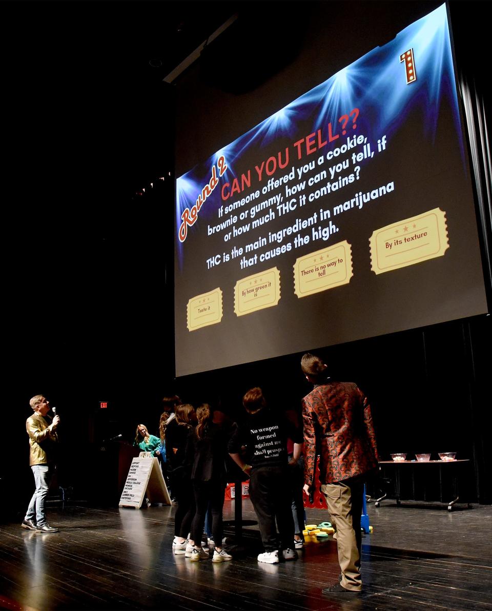 Ryan Nelson (left) of the Monroe County Intermediate School District and Monroe Police Officer Adam Theisen were the game show host of "Slay the Day, Don't Waste It Away." Several substance use questions were asked of the high school students. In this question, students were asked whether they could tell if a brownie or other treat contained THC.