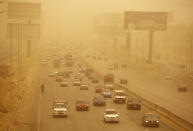 Vehicles drive during a sandstorm in Cairo, Egypt, Wednesday, Jan. 16, 2019 as a thick sandstorm cloaked parts of the Middle East. Sandstorms and harsh weather are blowing through parts of the Middle East, with visibility down in the Egyptian capital as an orange cloud of dust blocked out the sky and pedestrians used fabrics to cover their faces from the gusts. (AP Photo/Amr Nabil)