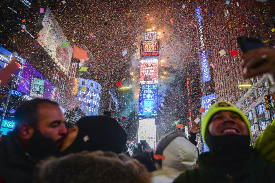 <p>People celebrate New Year as confetti fall down after the countdown to midnight in Times Square during New Year’s celebrations, Monday, Jan. 1, 2018, in New York. (Photo: Go Nakamura/AP) </p>