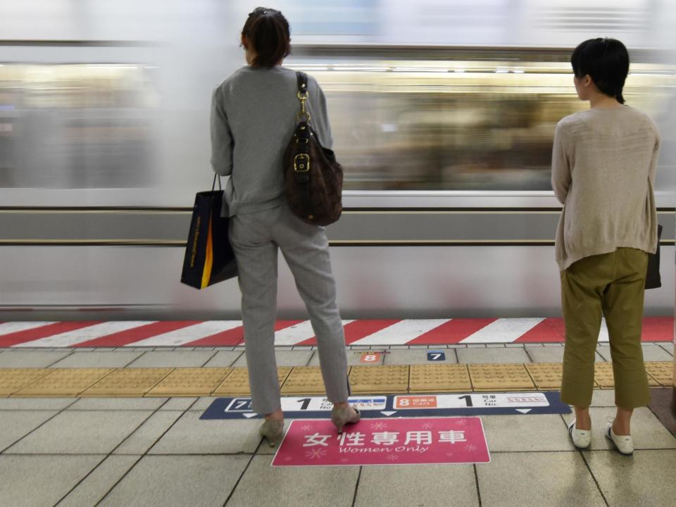 Women wait to board a women's-only carriage onboard a train on a subway station platform in Tokyo: AFP