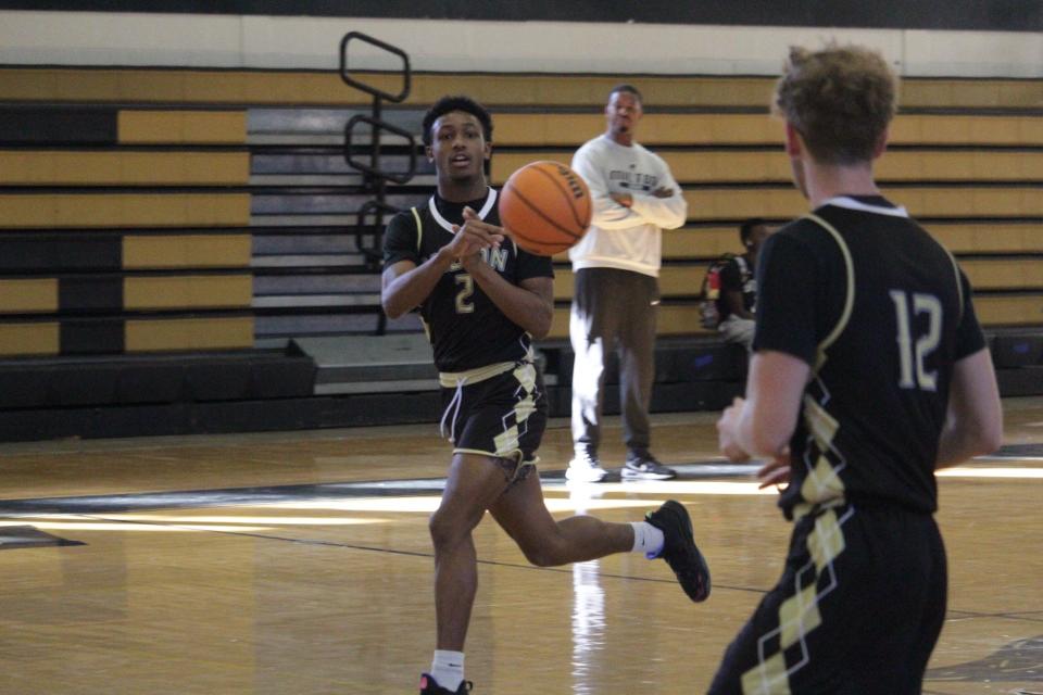 Milton's Ra'shaun Elzy (2) passes the ball to teammate Kyler Gardner (12) during a Panthers practice on Monday, Dec. 18, 2023.