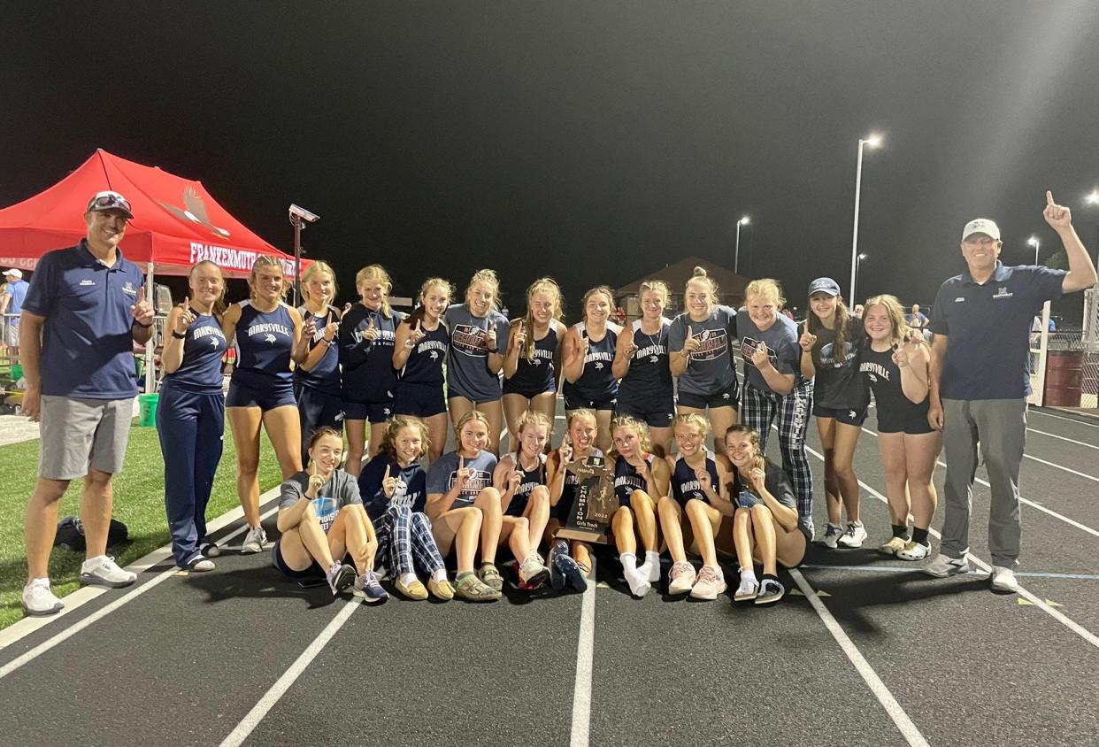 The Marysville girls track & field team celebrate after winning a Division 2 regional championship at Frankenmuth High School on Friday, May 20, 2022.