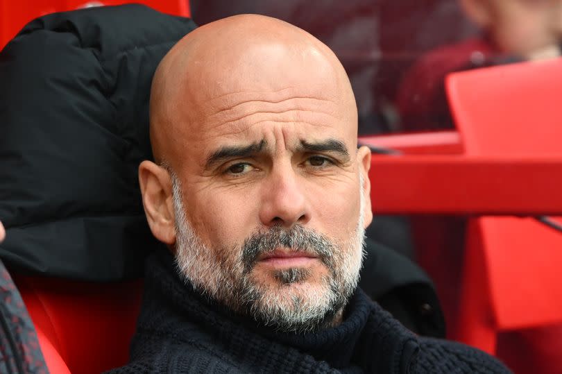 Pep Guardiola, manager of Manchester City looks on