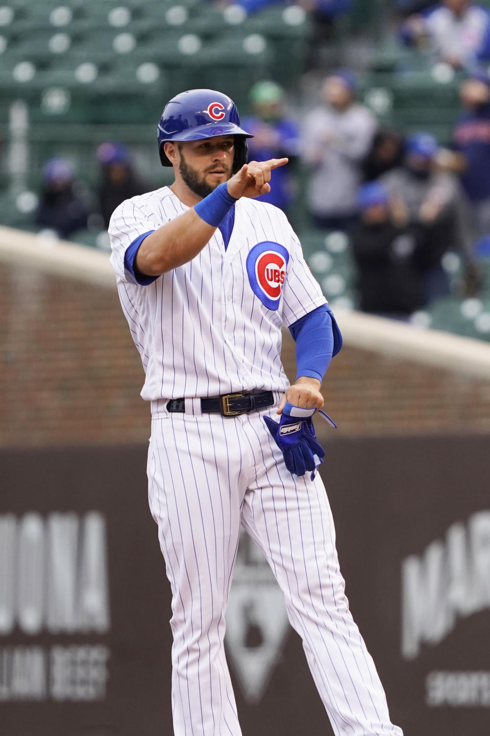 Chicago Cubs' David Bote gestures after hitting a three run double against the Los Angeles Dodgers during the first inning of the first baseball game of a doubleheader Tuesday, May, 4, 2021, in Chicago. (AP Photo/David Banks)