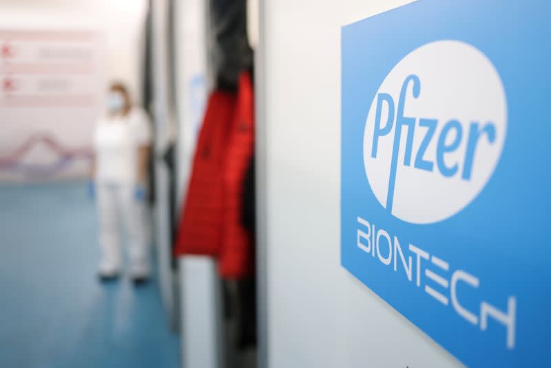 A healthcare worker waits in front of a booth where people receive doses of Pfizer's coronavirus disease (COVID-19) vaccine at Belgrade Fair vaccination center in Belgrade