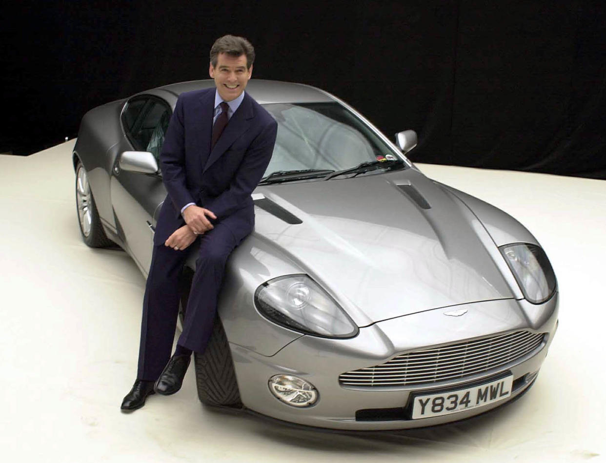 James Bond actor Pierce Brosnan with the Aston Martin Vanquish during a photocall for 'Bond 20', the working title for the latest film which starts production on the at Pinewood Studios in Iver, Bucks.     * 19/11/02: A group of convalescing Bond fans was today being treated to a sneak preview of the latest 007 adventure. Patients at St Thomas  Hospital in London were watching the new action film Die Another Day at a special screening at the UK s only hospital cinema. The showing of the new movie, which goes on general release on Wednesday, was the first preview to be held at MediCinema at the hospital.   (Photo by William Conran - PA Images/PA Images via Getty Images)