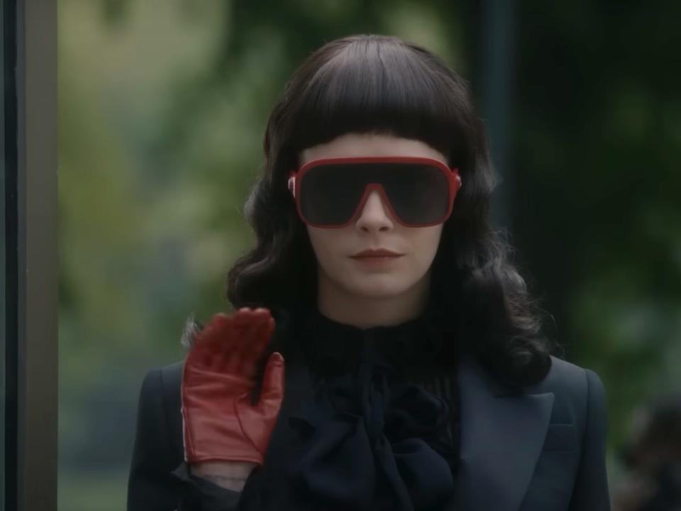 Cara Delevingne wearing red sunglasses in "American Horror Story: Delicate."